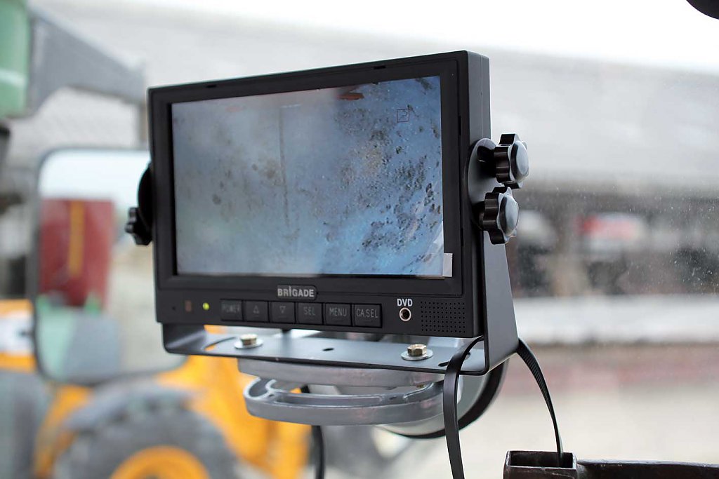 photo of the rear view camera monitor in the tractor cab attached to a mixer wagon