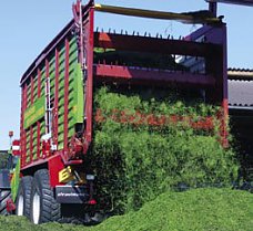 image of grass dropping out the back of a forage wagon