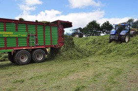 Forage Wagon Discharging Grass